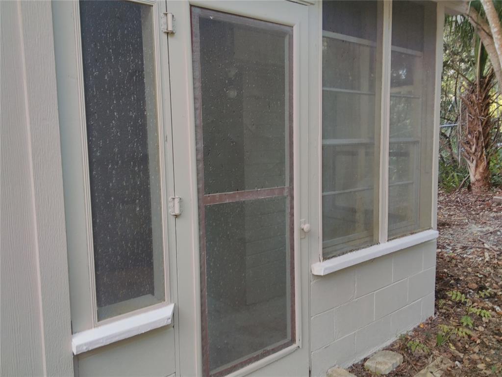 487 Rylane Street De Leon Springs, FL 32130 - Photo 30 of 40 a bathroom with a glass shower door