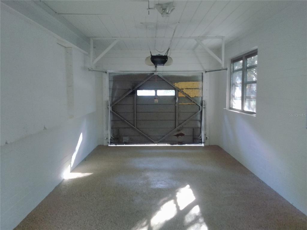 487 Rylane Street De Leon Springs, FL 32130 - Photo 33 of 40 a view of an empty room with windows and chandelier fan