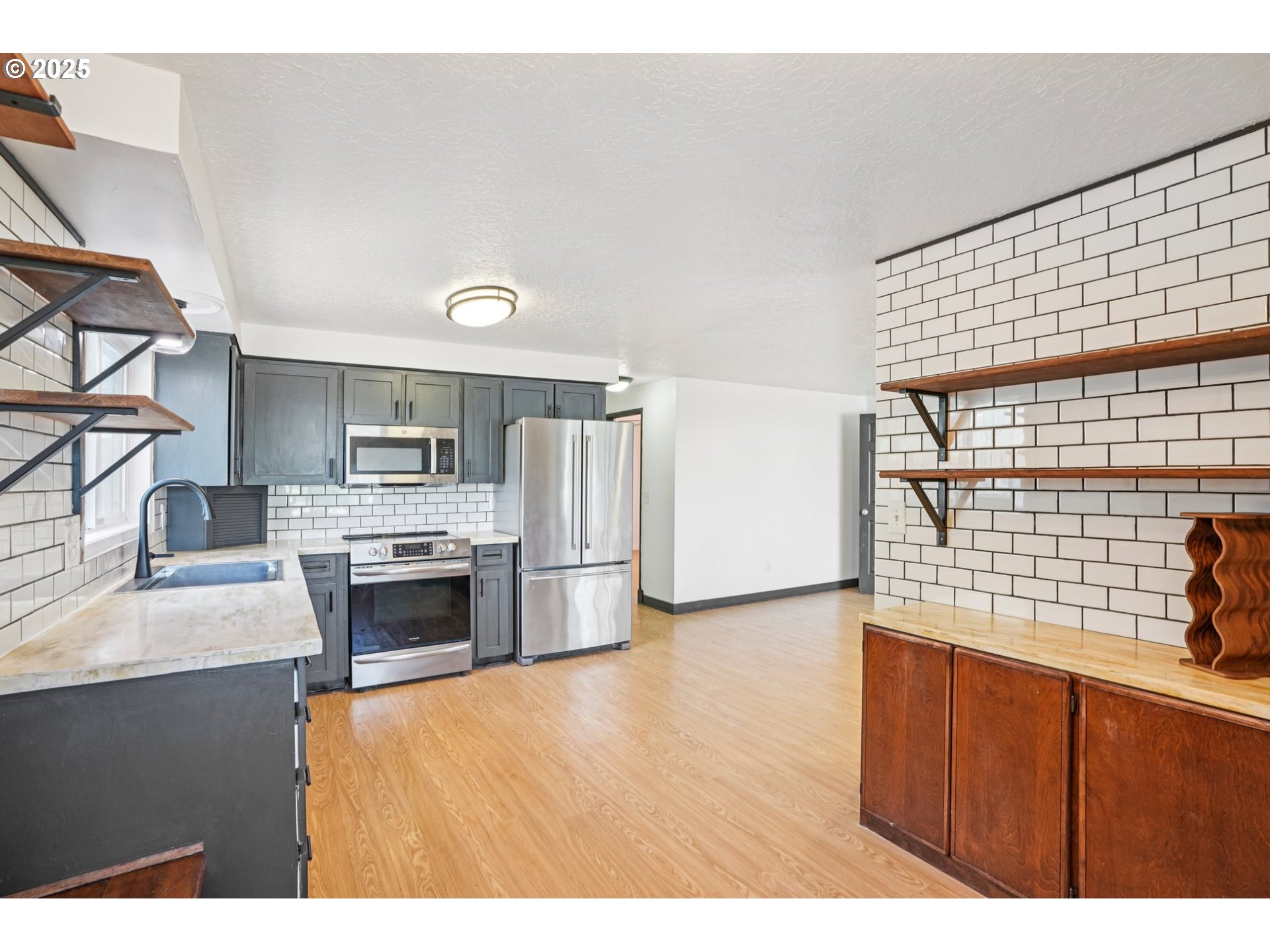 1019 Linn Avenue Oregon City, OR 97045 - Photo 11 of 27 a kitchen with refrigerator and cabinets