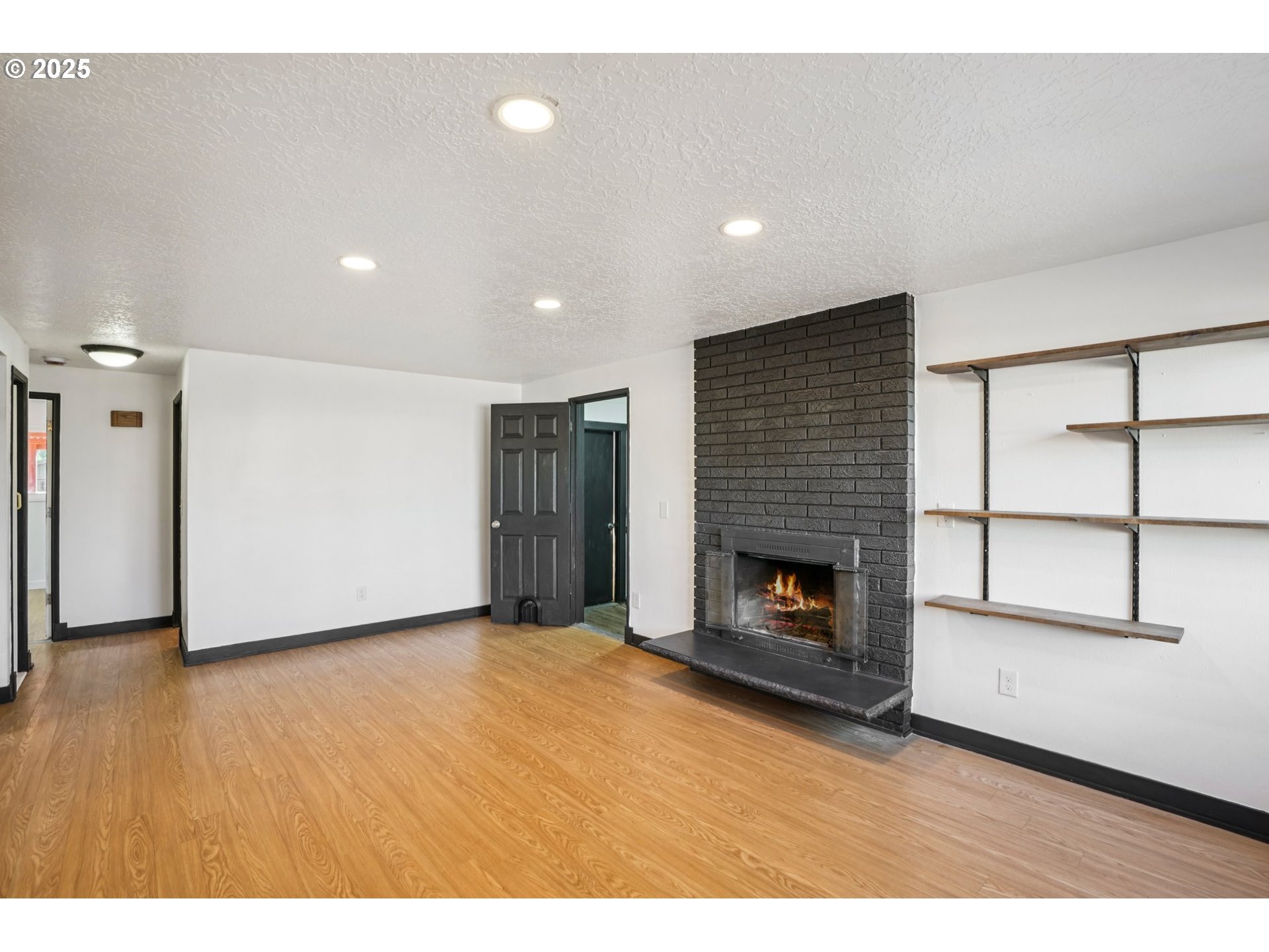 1019 Linn Avenue Oregon City, OR 97045 - Photo 5 of 27 a view of an empty room with a fireplace and a window