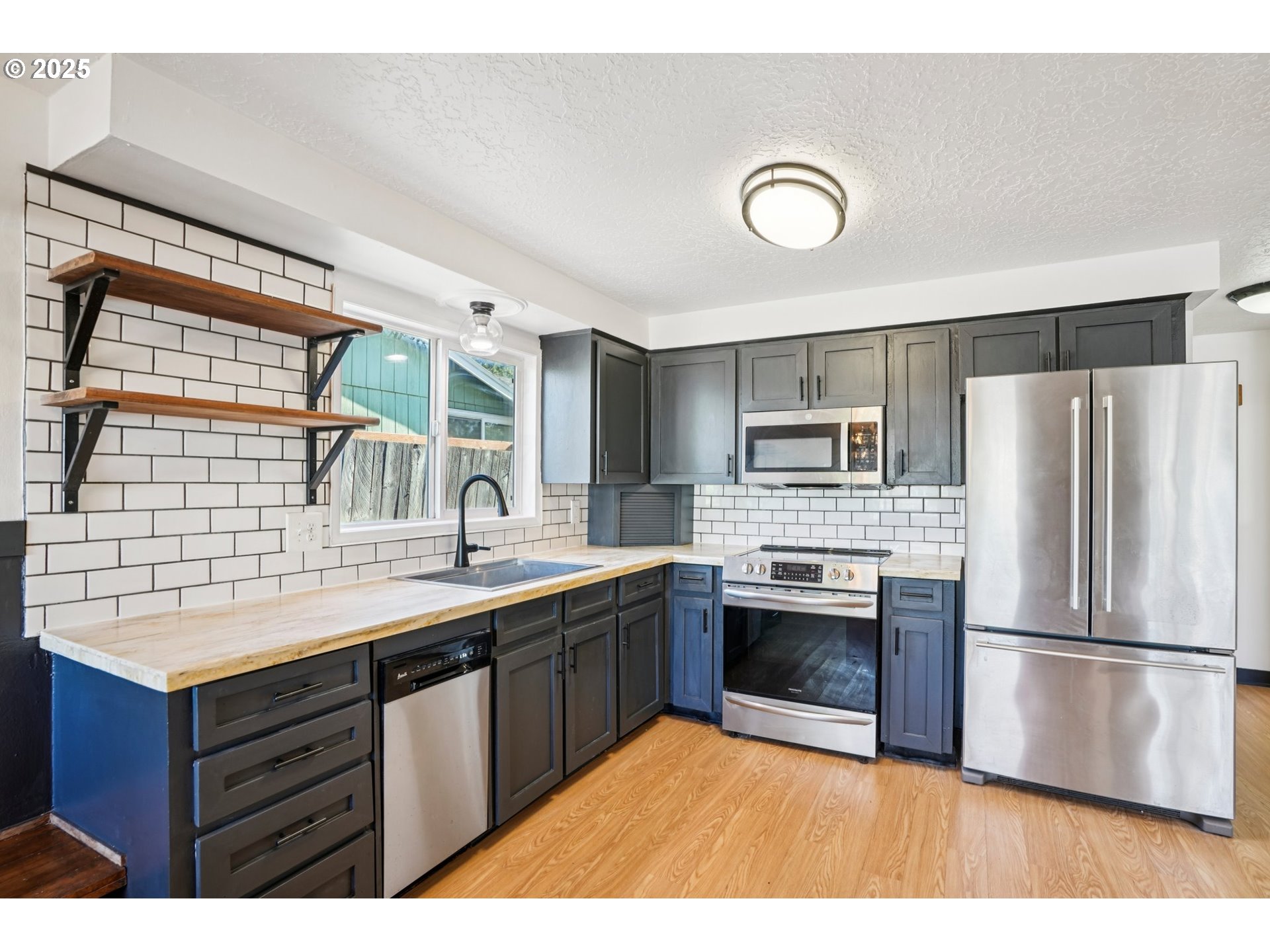 1019 Linn Avenue Oregon City, OR 97045 - Photo 10 of 27 a kitchen with stainless steel appliances granite countertop a sink stove and refrigerator