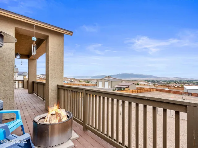 a view of a balcony with a dining table and a chairs