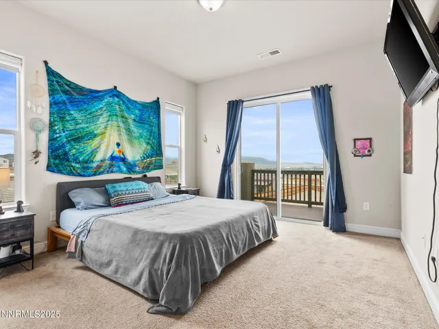 a bedroom with a bed and a large window