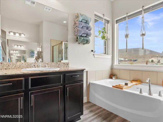 a bathroom with a tub sink and mirror