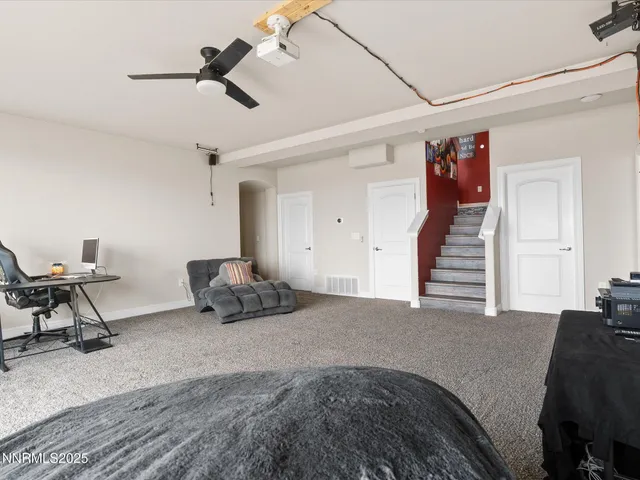 a bedroom with furniture and a ceiling fan