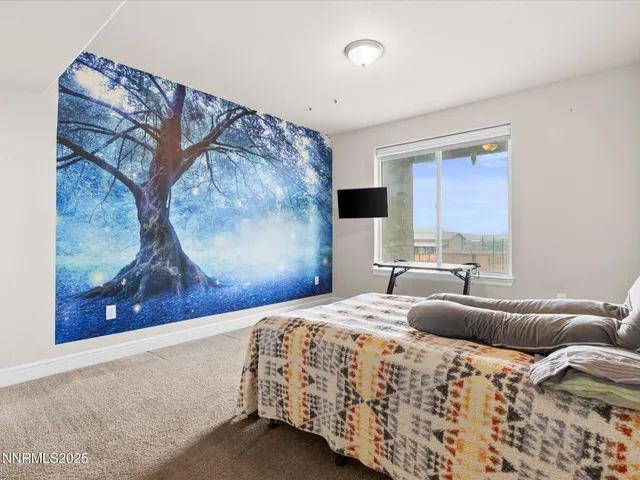 a bedroom with a bed and a painting on the wall