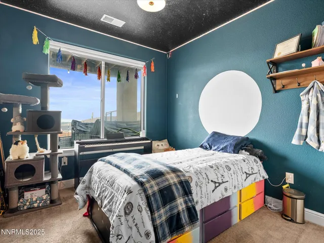 a bedroom with bed and a mirror