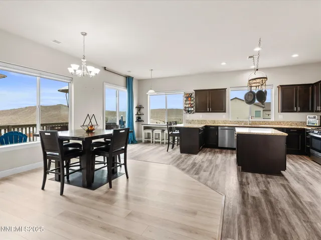 a large kitchen with a table and chairs