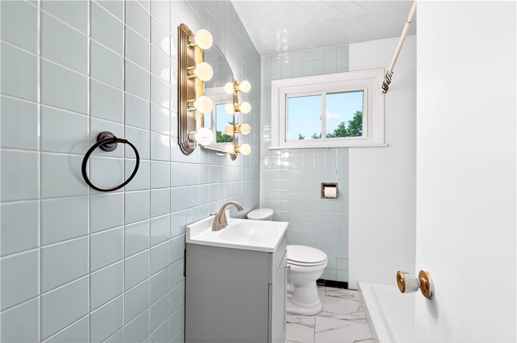 124 Bunker Hill Road Aliquippa, PA 15001 - Photo 24 of 37 a bathroom with a sink toilet and mirror