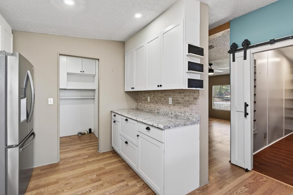 2744 Roy Sikes Road Hilliard, FL 32046 - Photo 27 of 97 a kitchen with stainless steel appliances granite countertop a refrigerator and a stove