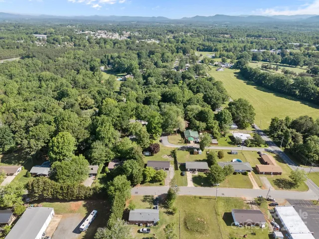 an aerial view of residential houses with outdoor space and river