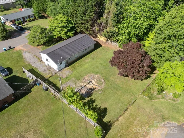 an aerial view of a residential houses with outdoor space