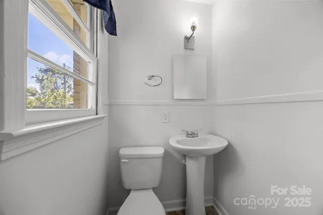 a bathroom with a sink mirror and toilet