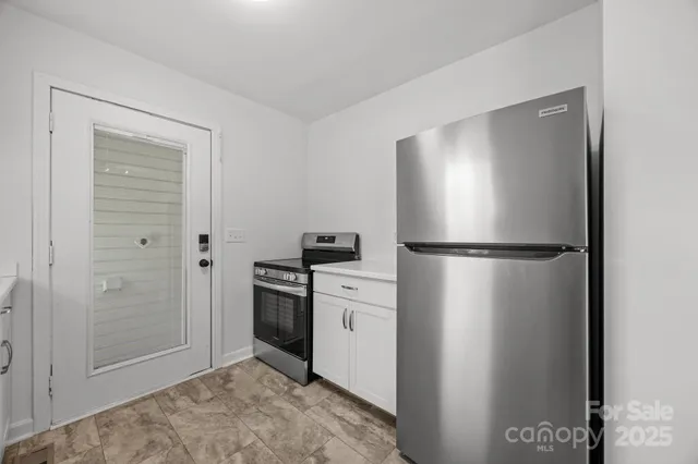 a kitchen with a refrigerator and a sink