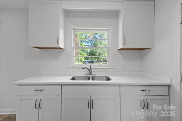 a kitchen with a sink and cabinets