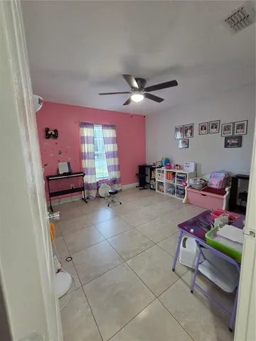 a view of a room with gym equipment and a large window
