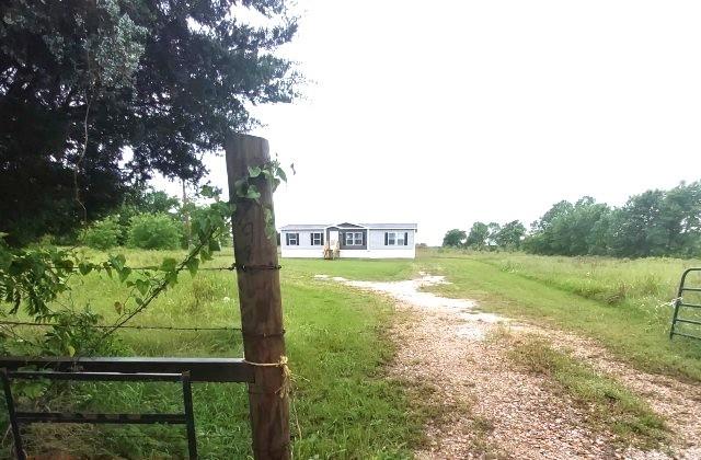 798 North 4190 Road Hugo, OK 74743 - Photo 2 of 16 a view of a garden from a lake