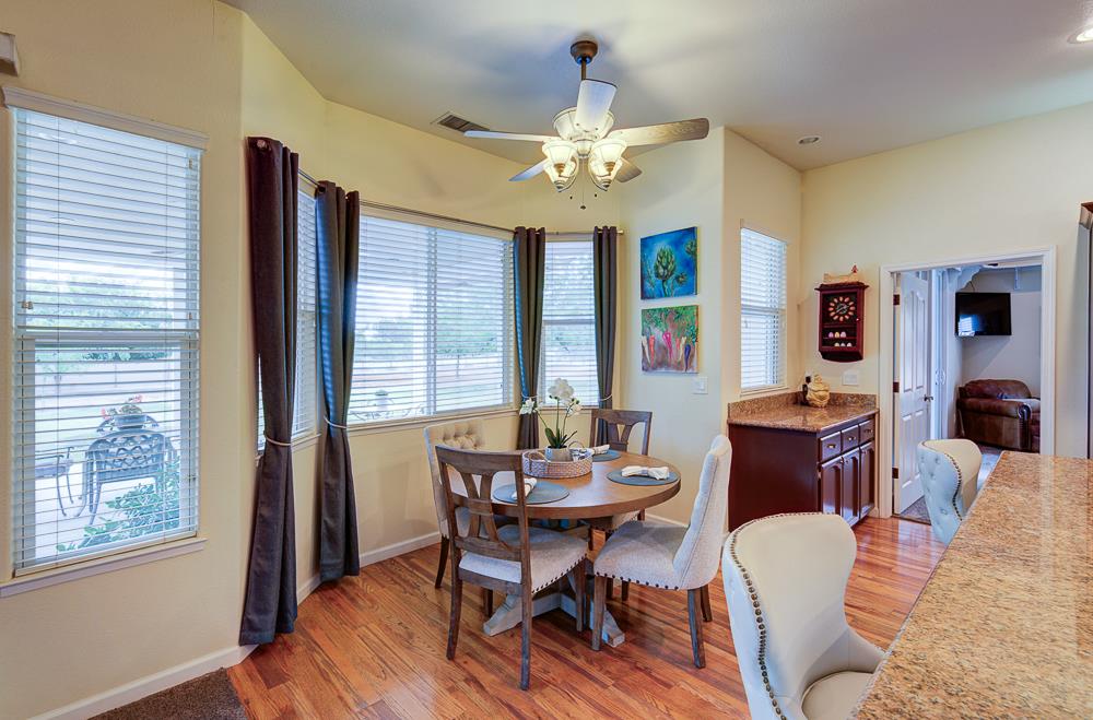 17465 Monreal Road Madera, CA 93636 - Photo 28 of 59 a view of a dining room with furniture window and wooden floor
