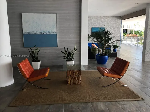 a living room with furniture and a potted plant
