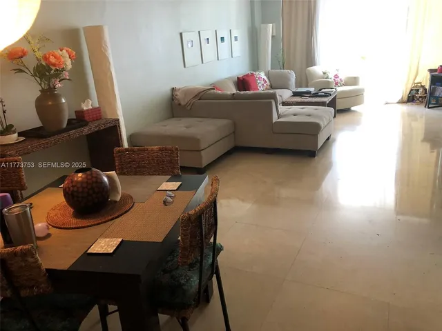 a living room with furniture and a mirror