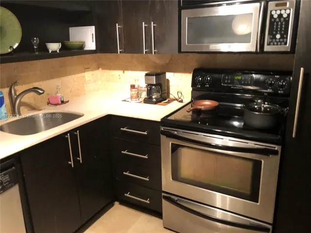 a stove top oven sitting inside of a kitchen
