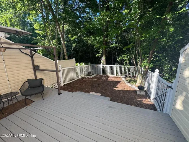 a view of a deck with couches and wooden floor