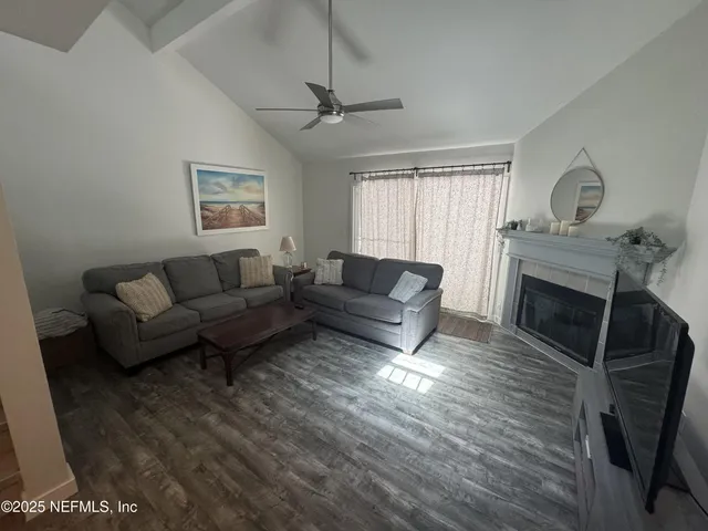 a living room with furniture a window and a fireplace