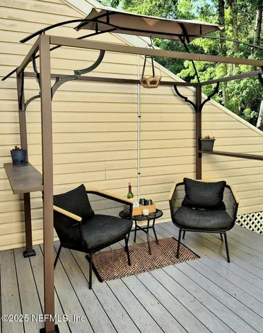 a balcony with table and chairs