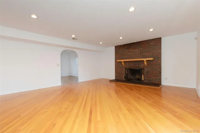 a view of empty room with a fireplace