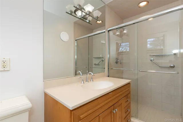a bathroom with a sink a mirror and a shower