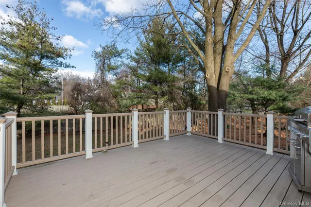 a view of balcony with wooden floor and fence