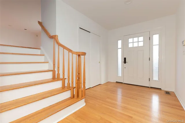 a view of entryway with wooden floor and stairs