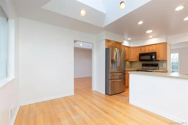 a kitchen with stainless steel appliances a refrigerator and a stove top oven