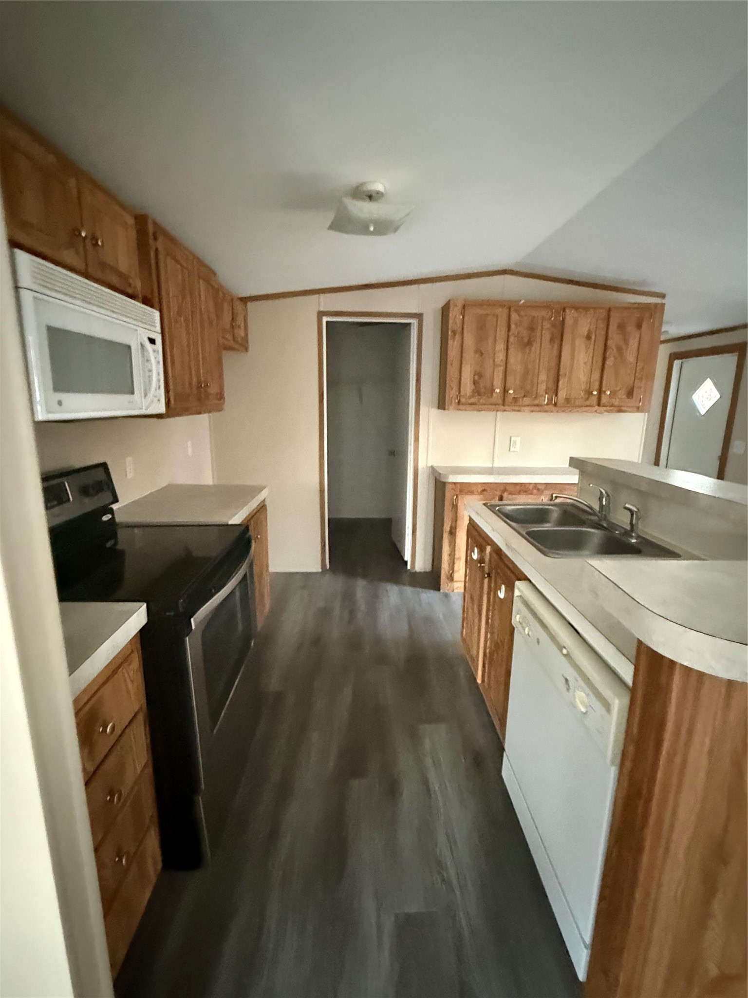 144 Private Road Cleveland, TX 77327 - Photo 13 of 17 a kitchen that has a sink wooden cabinets and a stove top oven