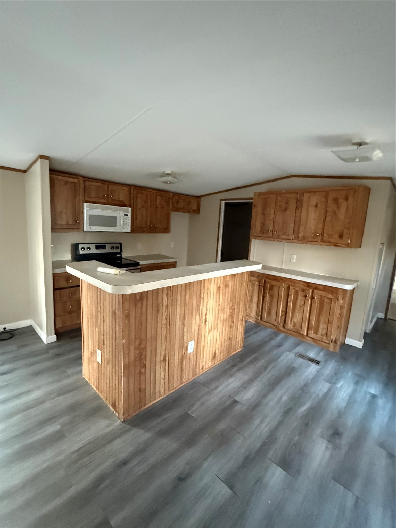 144 Private Road Cleveland, TX 77327 - Photo 14 of 17 a kitchen with stainless steel appliances wooden cabinets and a wooden floor