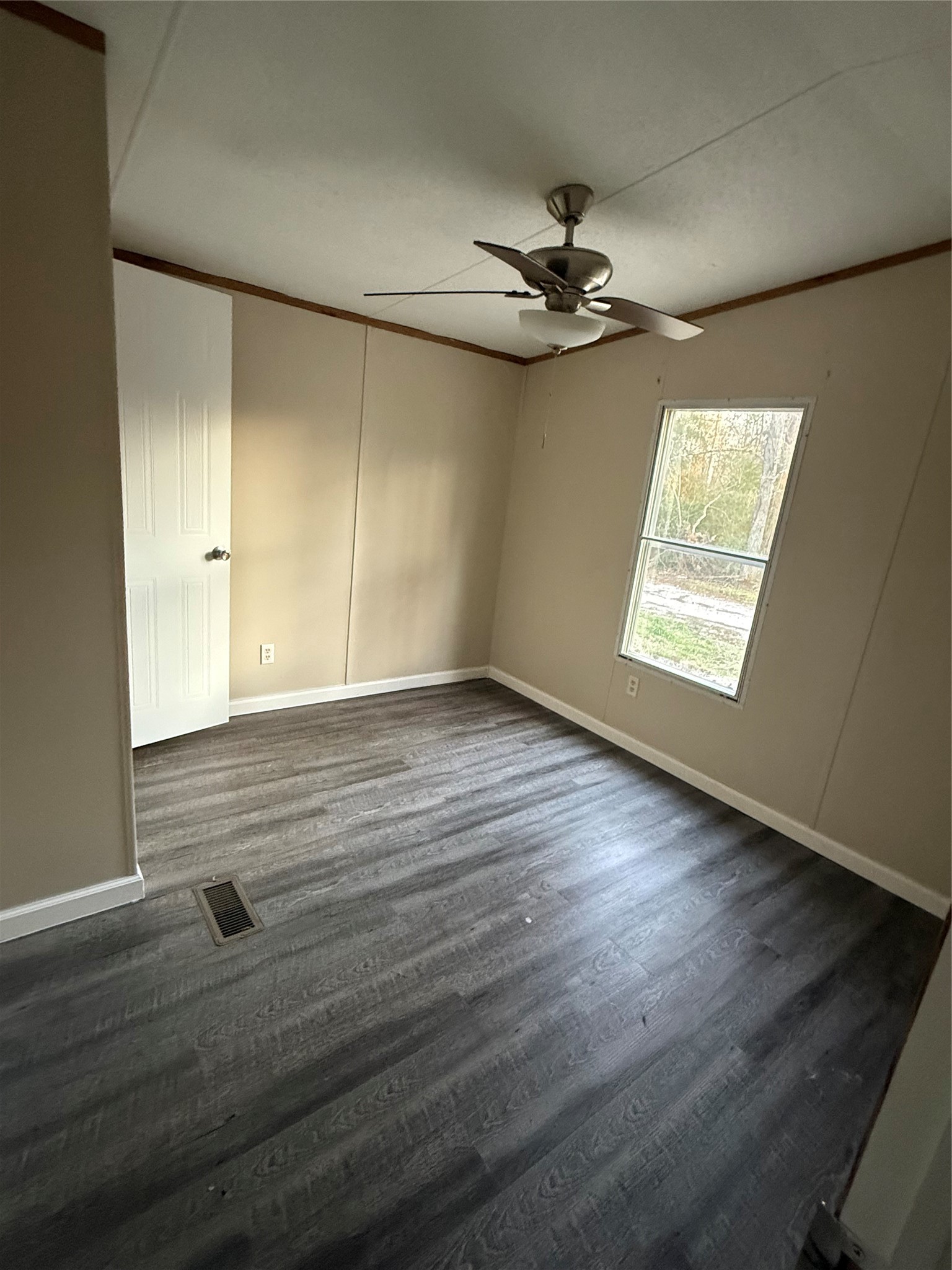 144 Private Road Cleveland, TX 77327 - Photo 4 of 17 an empty room with wooden floor fan and windows