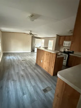 a view of a kitchen with wooden floor