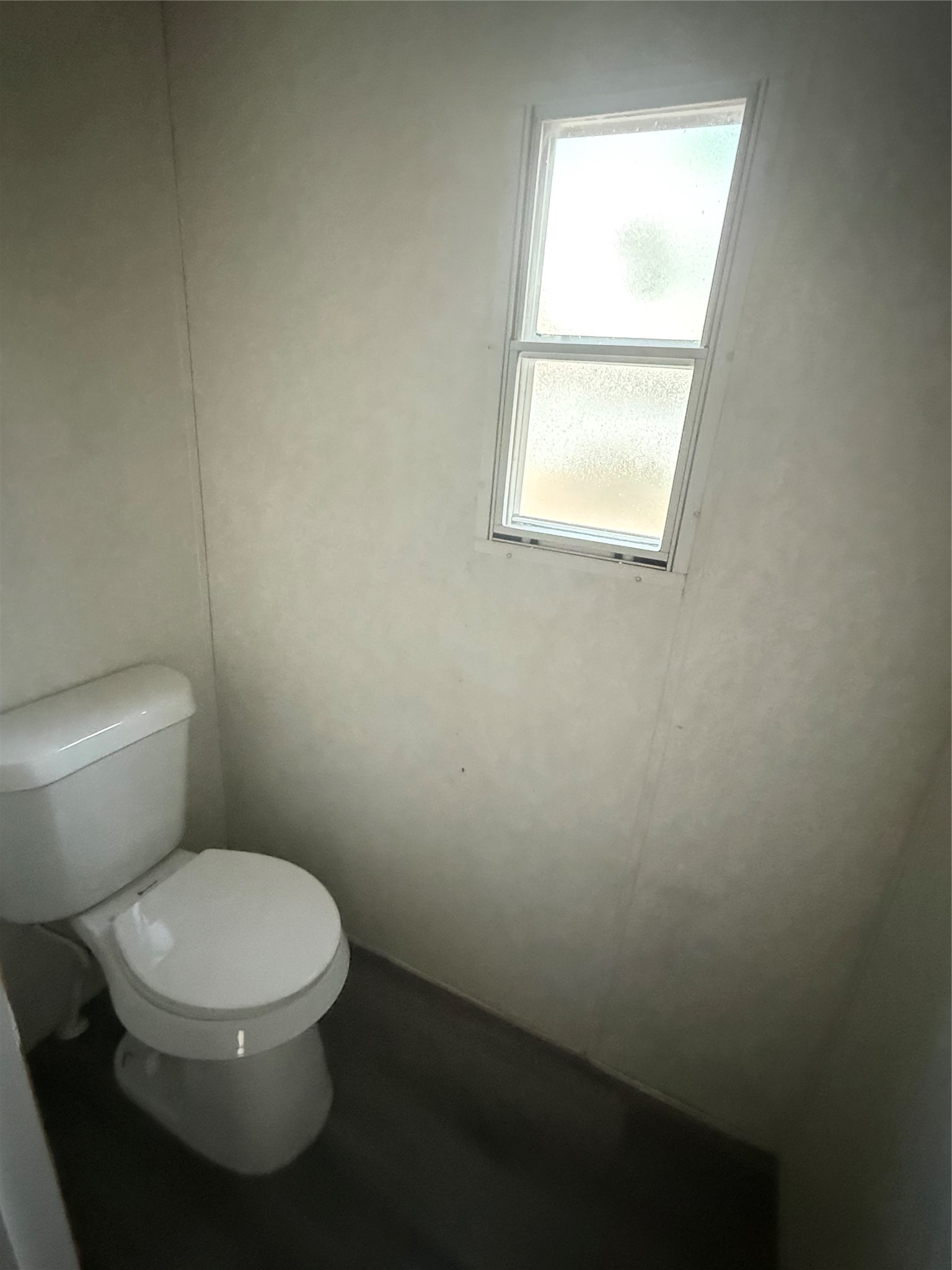 144 Private Road Cleveland, TX 77327 - Photo 8 of 17 a white toilet sitting in a bathroom next to a window