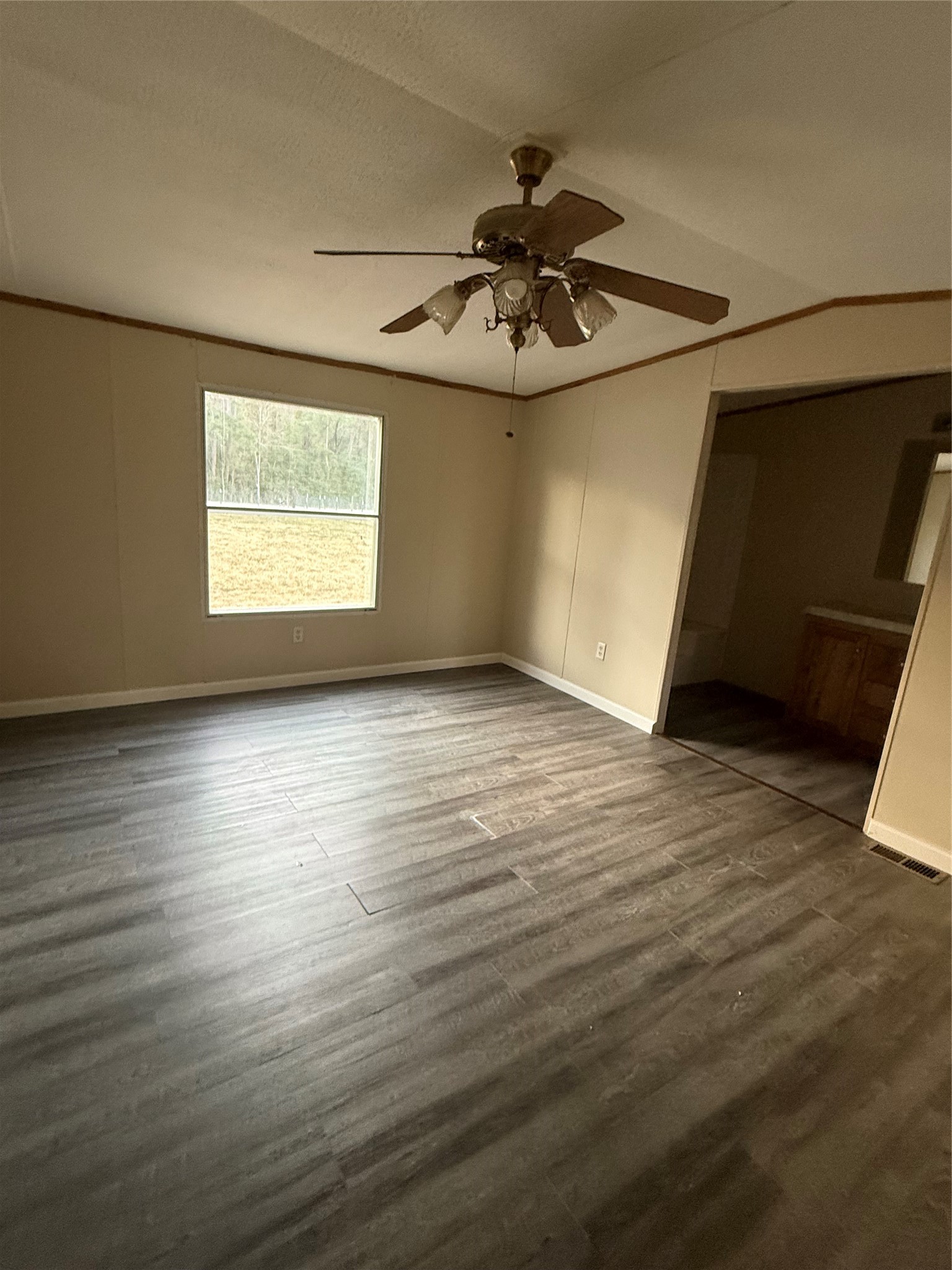 144 Private Road Cleveland, TX 77327 - Photo 10 of 17 an empty room with wooden floor fan and windows