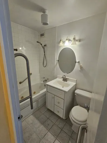 a bathroom with a sink toilet and a mirror