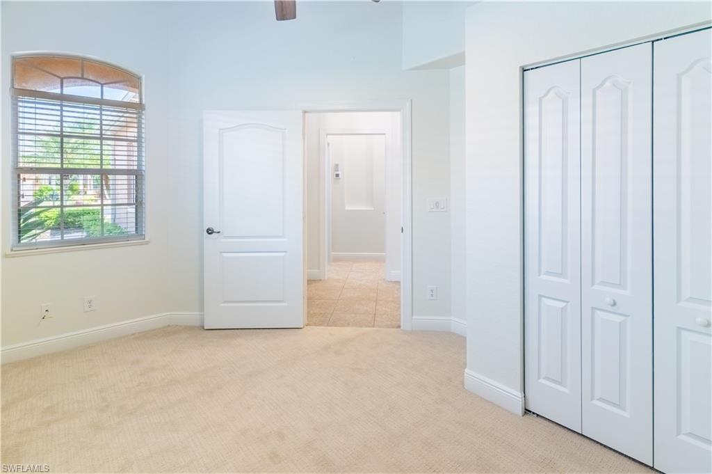 15313 Cortona Way Naples, FL 34120 - Photo 12 of 28 an empty room with windows