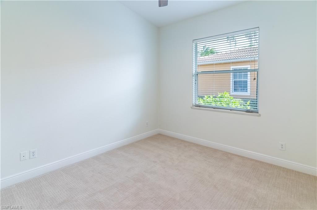 15313 Cortona Way Naples, FL 34120 - Photo 15 of 28 an empty room with a window