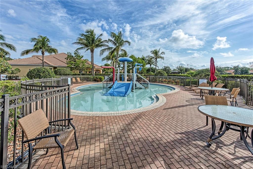 15313 Cortona Way Naples, FL 34120 - Photo 23 of 28 a view of a swimming pool with lounge chairs