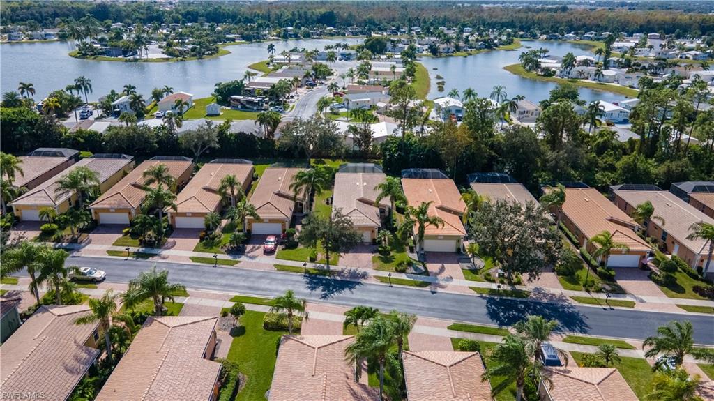 15313 Cortona Way Naples, FL 34120 - Photo 27 of 28 an aerial view of residential houses with outdoor space and lake view