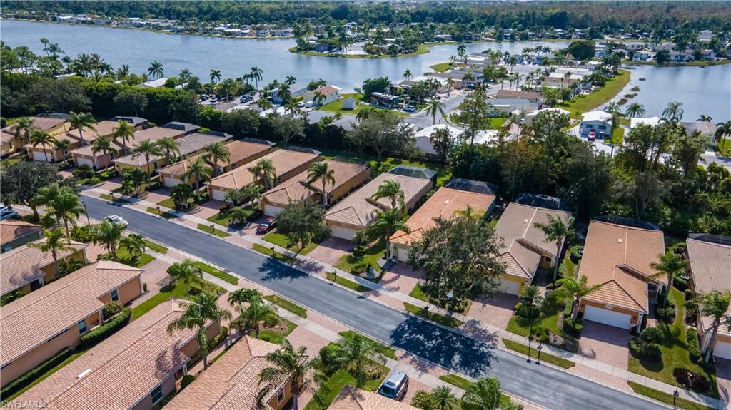 15313 Cortona Way Naples, FL 34120 - Photo 28 of 28 an aerial view of residential houses with outdoor space and lake view