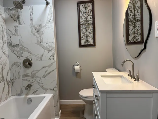 a bathroom with a toilet sink and tub