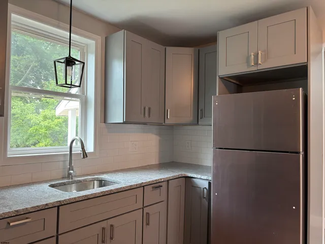 a kitchen with a refrigerator and a sink