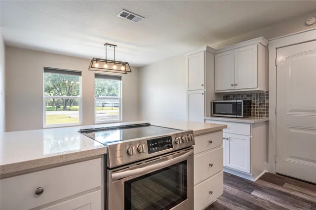a view of a kitchen with a sink and a window