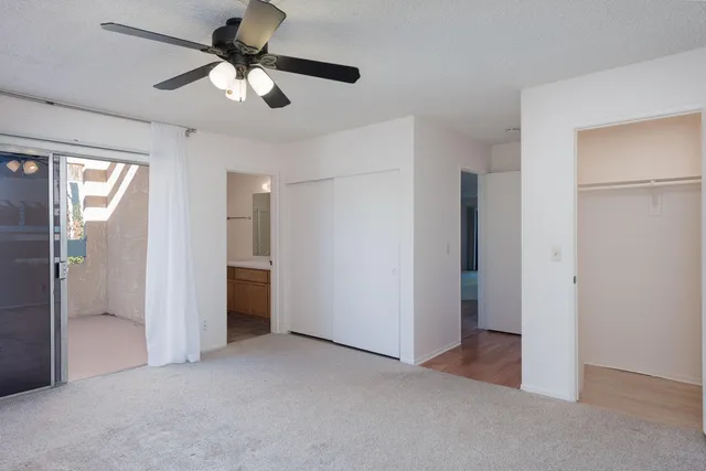a view of empty room with wooden floor and fireplace