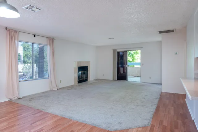 a view of a big room with closet and a chandelier fan